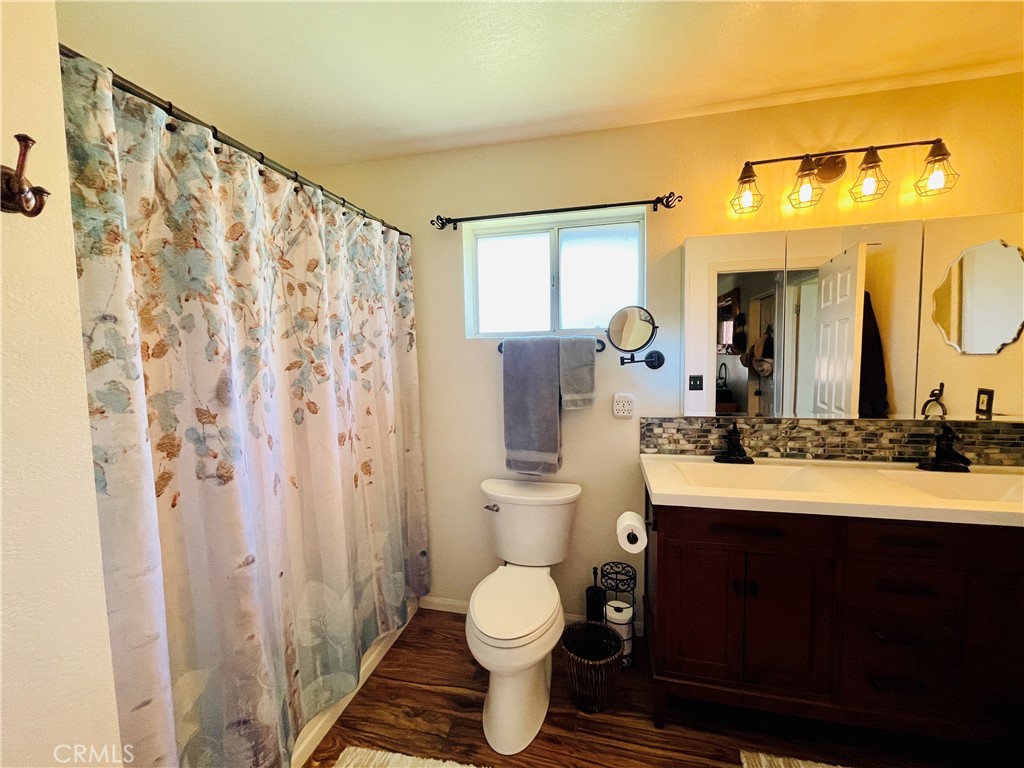 921 Piru Way Frazier Park, CA 93225 - Photo 20 of 54 a bathroom with a toilet sink and mirror