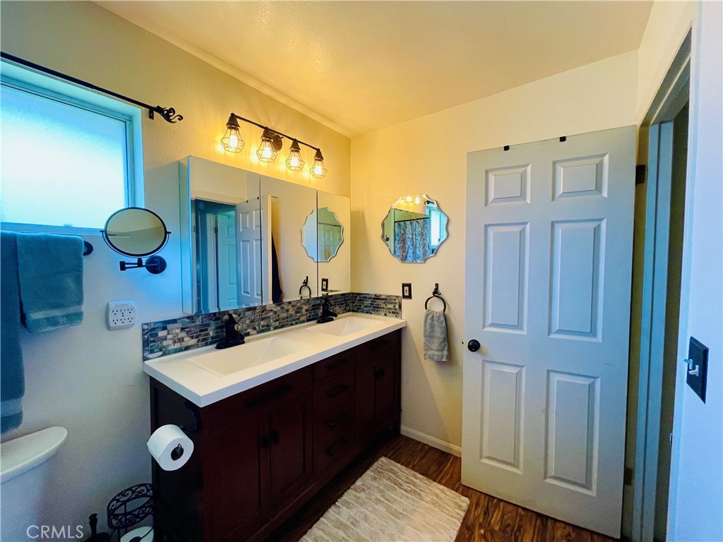 921 Piru Way Frazier Park, CA 93225 - Photo 21 of 54 a bathroom with a sink mirror and toilet