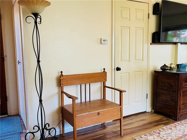 a living room with furniture a fireplace and a large window