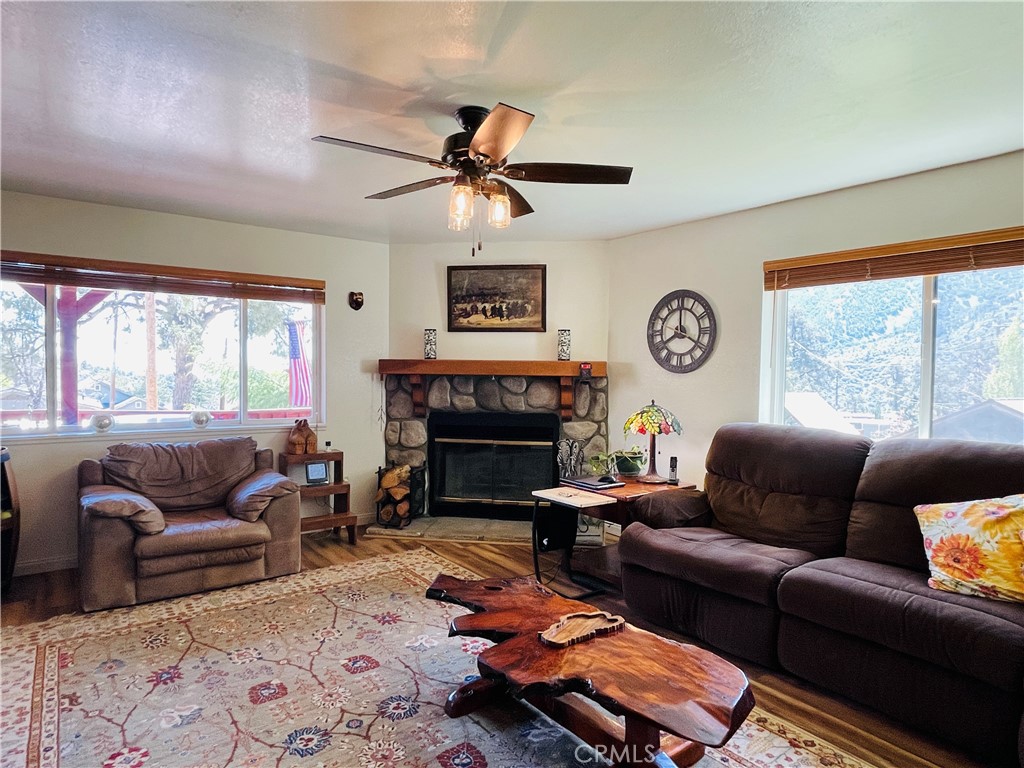 921 Piru Way Frazier Park, CA 93225 - Photo 24 of 54 a living room with furniture a fireplace and a large window