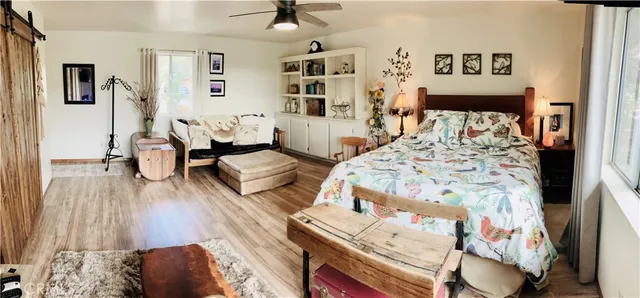 a view of a house with a big yard plants and large trees