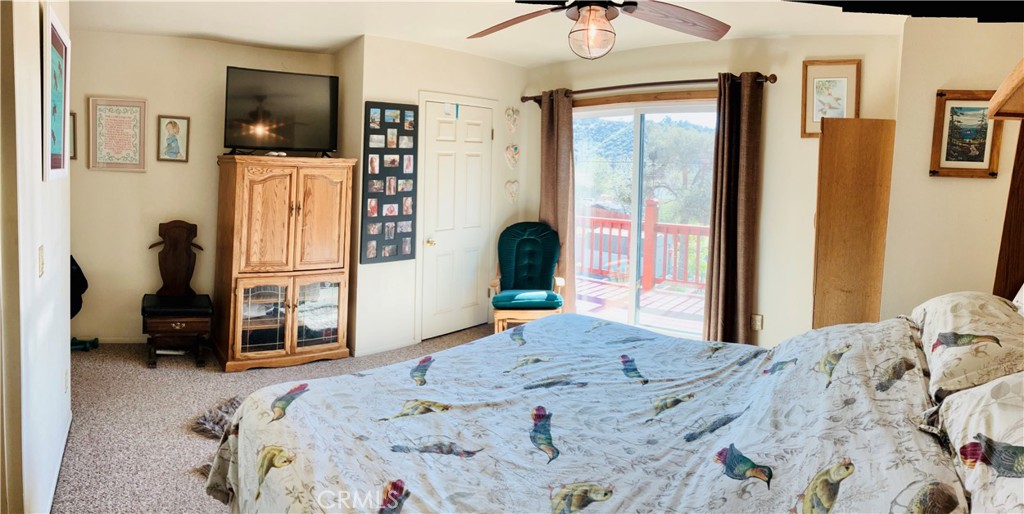 921 Piru Way Frazier Park, CA 93225 - Photo 41 of 54 a bedroom with a bed and a flat tv screen on dresser