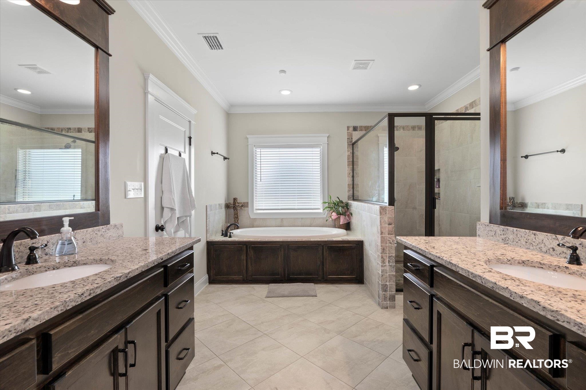 24821 Austin Road Daphne, AL 36526 - Photo 11 of 24 Bathroom featuring a stall shower, a bath, two vanities, recessed lighting, and ornamental molding