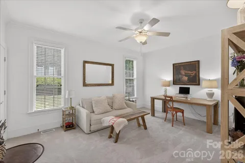 a living room with furniture a table and a window