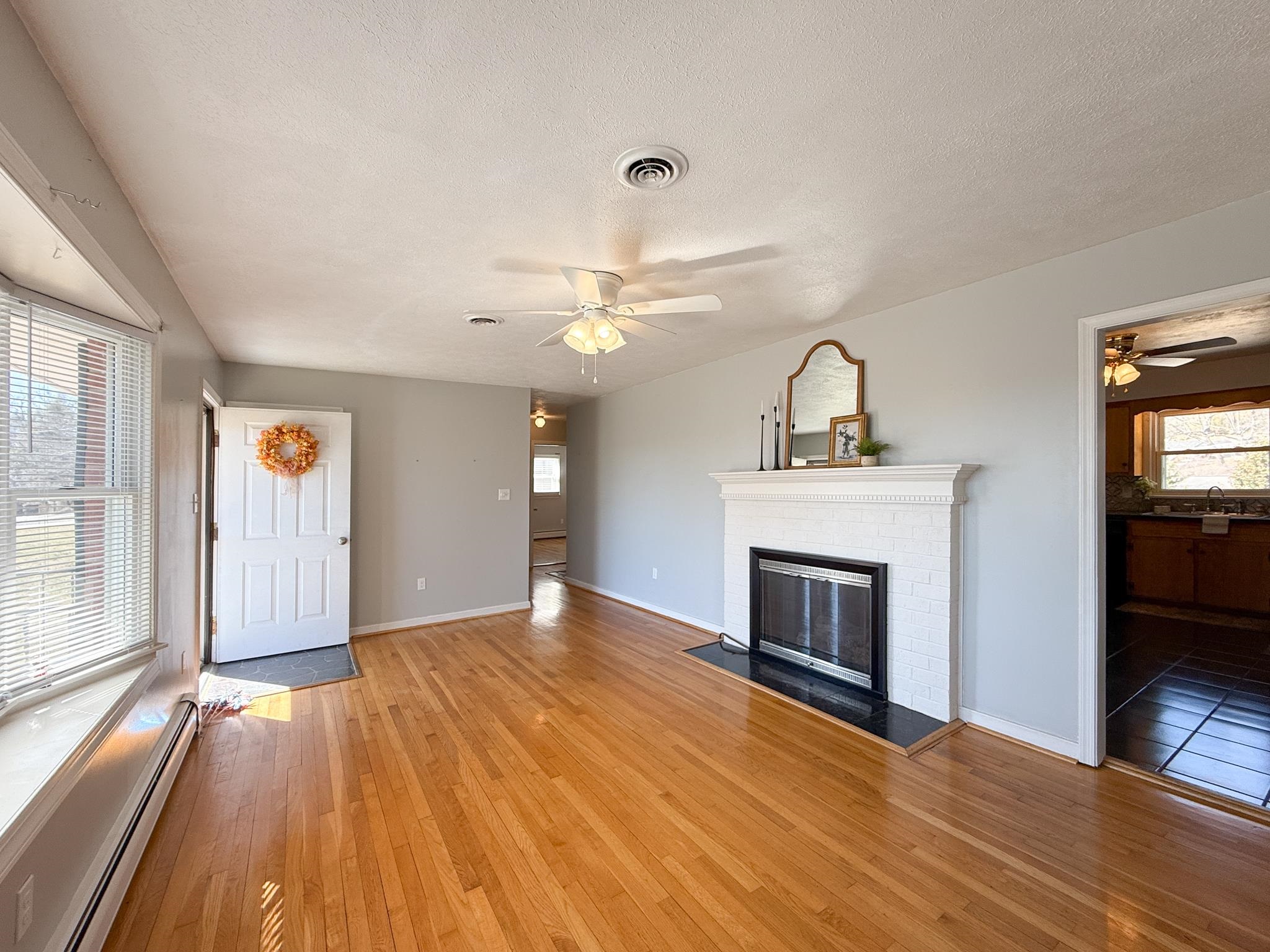 1606 Ridgeway Drive Staunton, VA 24401 - Photo 13 of 27 wooden floor fireplace and windows in an empty room