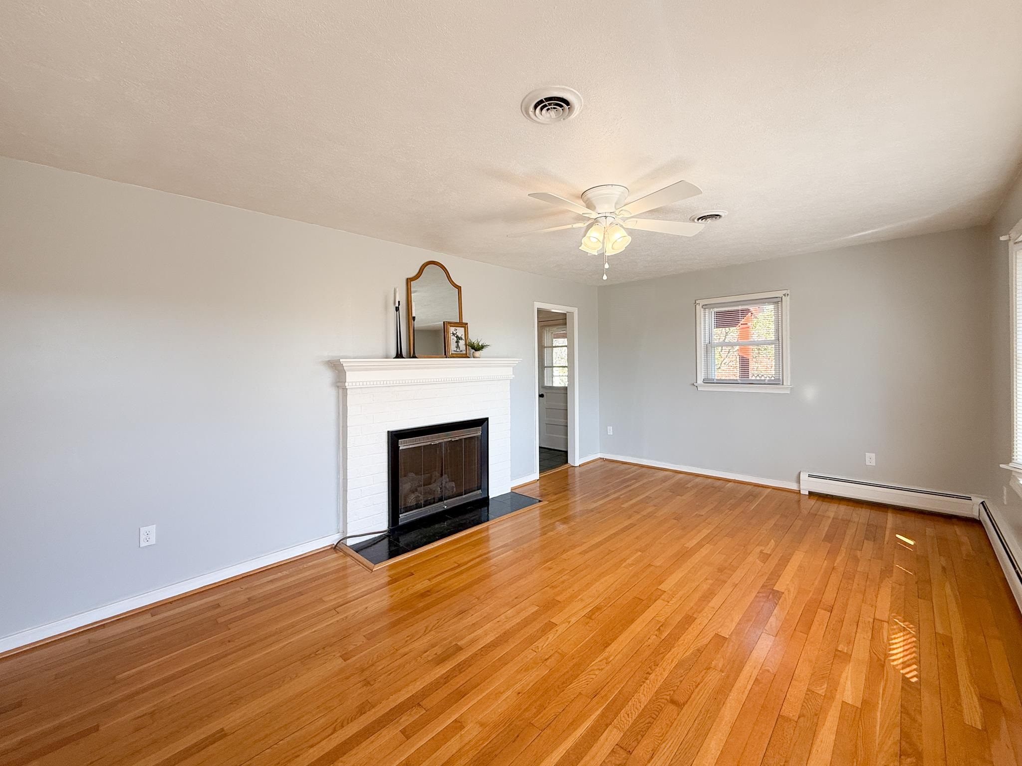 1606 Ridgeway Drive Staunton, VA 24401 - Photo 10 of 27 a view of empty room with fireplace and wooden floor