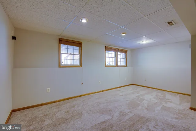 a view of an empty room with windows