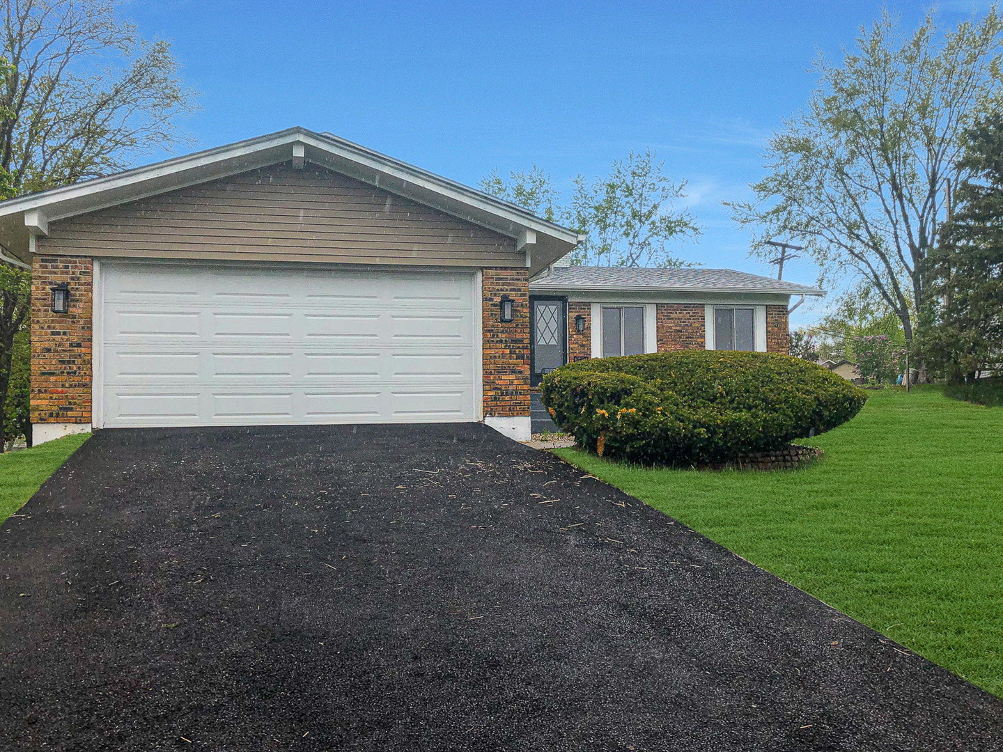 200 Hickory Drive Lindenhurst, IL 60046 - Photo 1 of 34 a front view of a house with a yard and garage