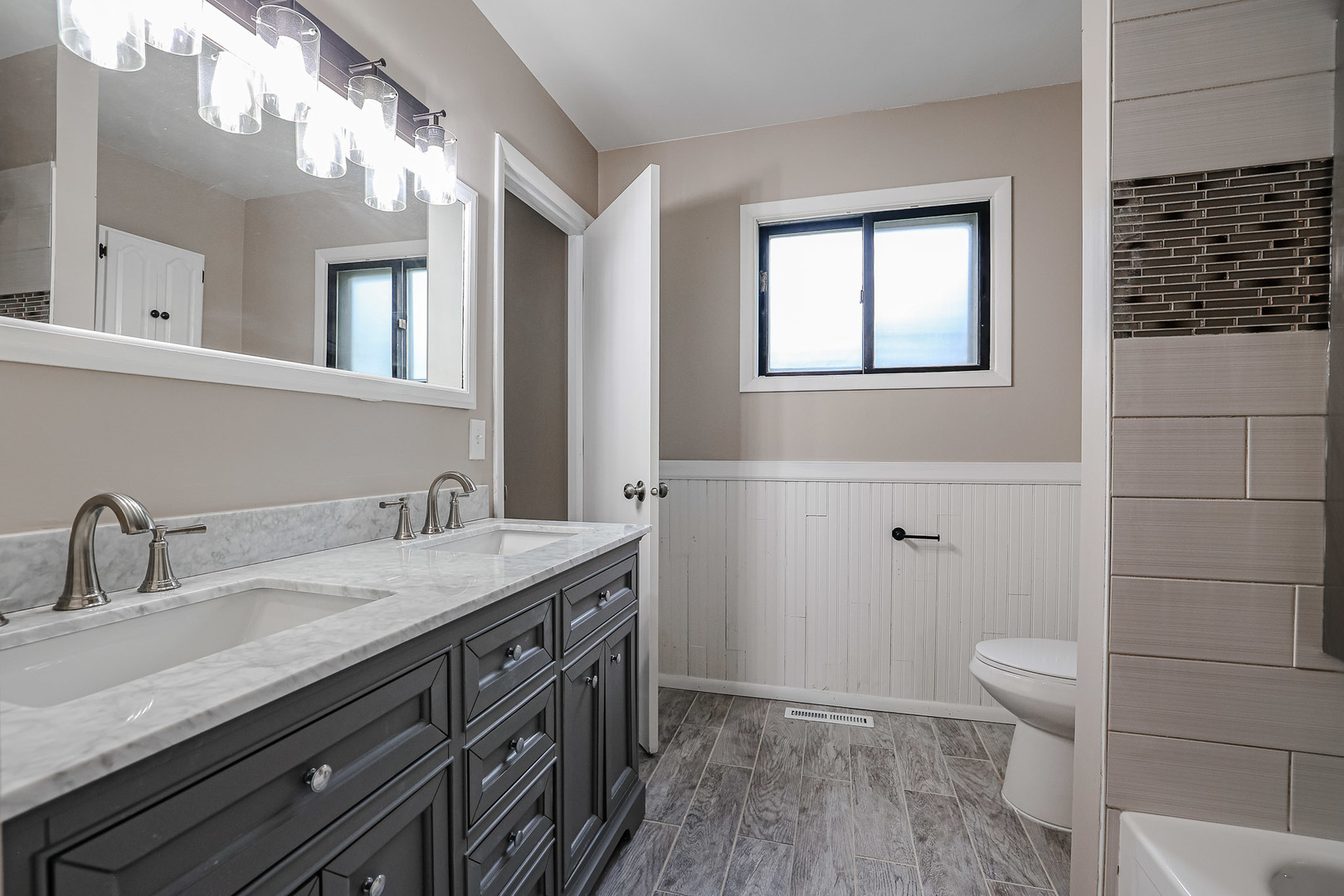 200 Hickory Drive Lindenhurst, IL 60046 - Photo 17 of 34 a bathroom with a granite countertop sink a toilet and a mirror