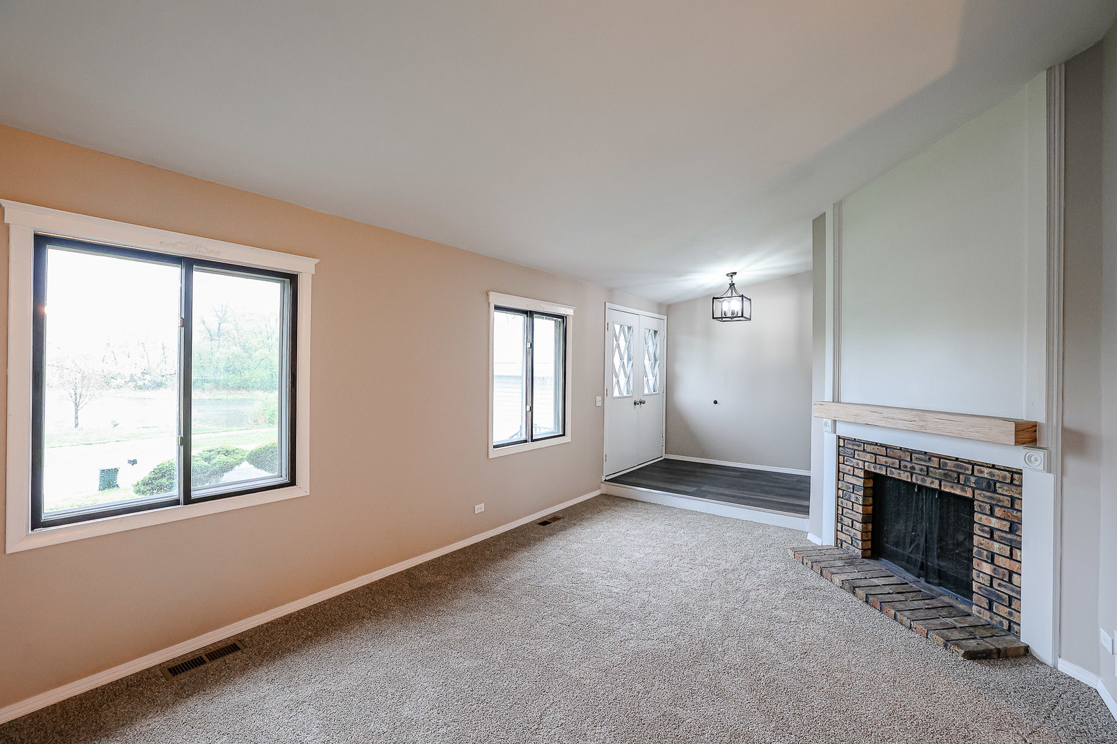 200 Hickory Drive Lindenhurst, IL 60046 - Photo 6 of 34 an empty room with windows and fireplace