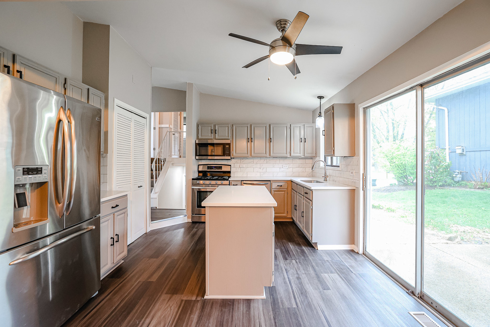 200 Hickory Drive Lindenhurst, IL 60046 - Photo 9 of 34 a kitchen with a refrigerator a sink and dishwasher with wooden floor