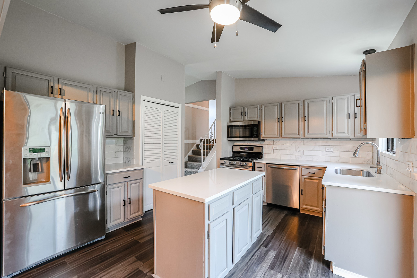 200 Hickory Drive Lindenhurst, IL 60046 - Photo 10 of 34 a kitchen with stainless steel appliances a refrigerator sink and microwave