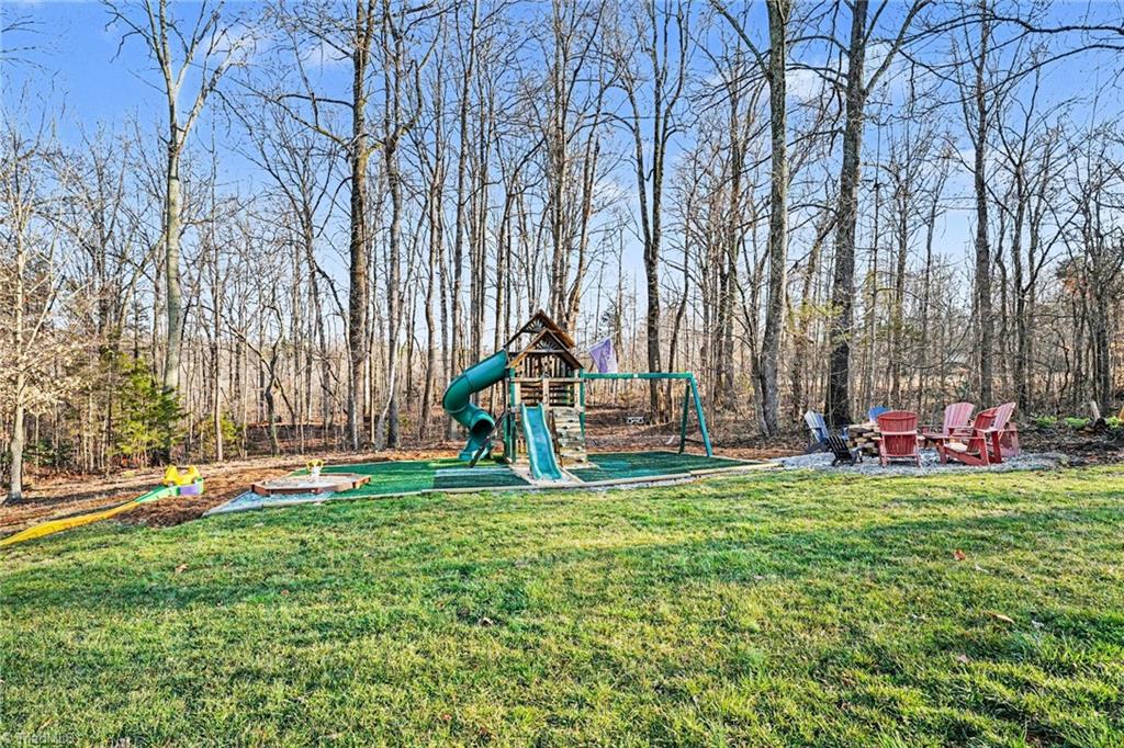 1470 Robert Beck Road Lexington, NC 27292 - Photo 38 of 50 Cute play space with artificial turf for young ones to enjoy and nearby firepit for young at heart!