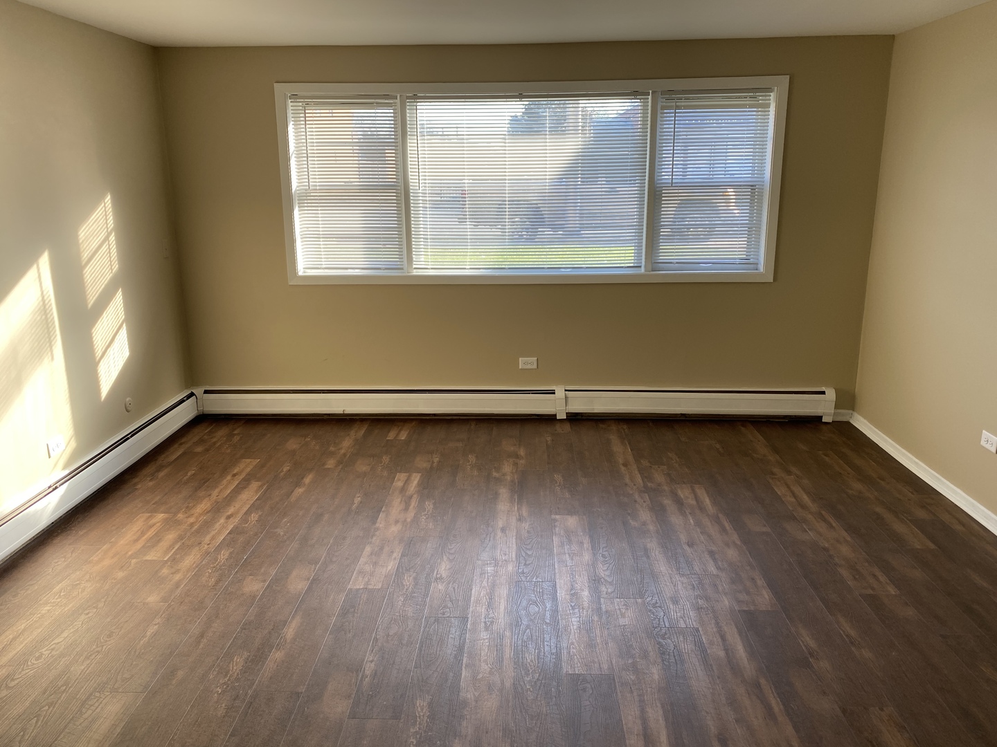 6742 West 63rd Street, Unit 1 Chicago, IL 60638 - Photo 11 of 21 an empty room with wooden floor and windows