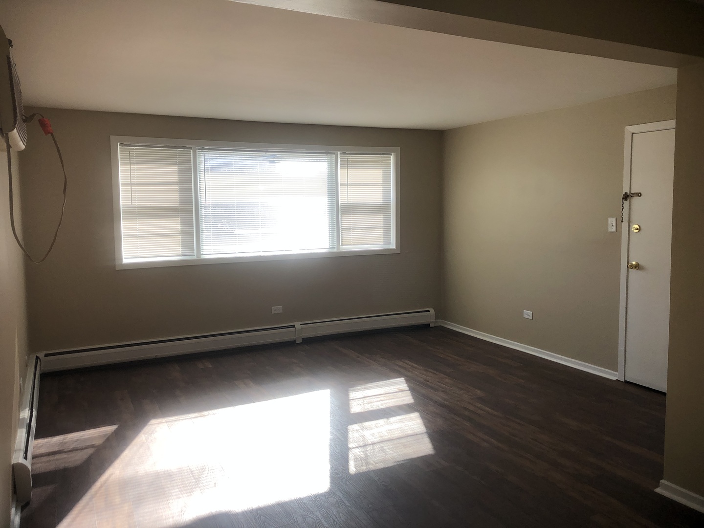 6742 West 63rd Street, Unit 1 Chicago, IL 60638 - Photo 14 of 21 an empty room with wooden floor and windows