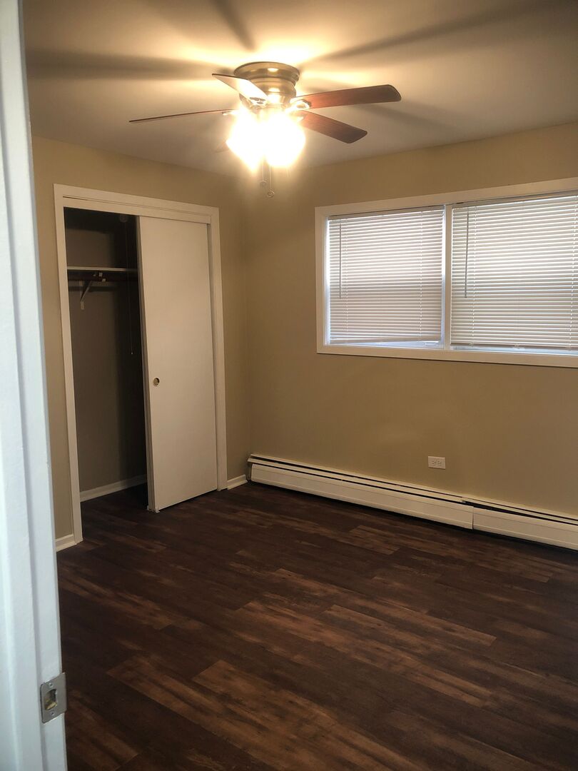 6742 West 63rd Street, Unit 1 Chicago, IL 60638 - Photo 17 of 21 a view of an empty room with wooden floor and a window
