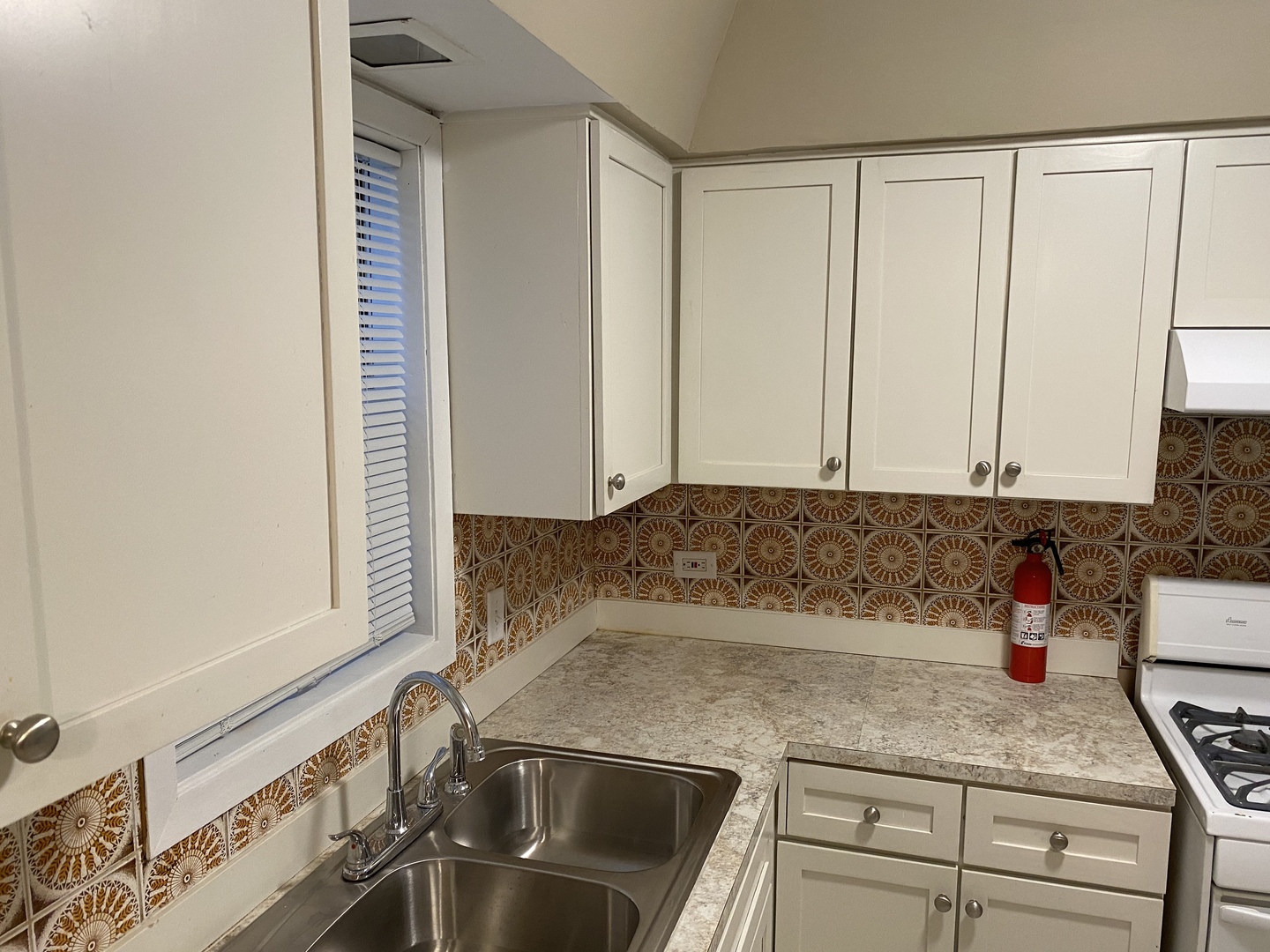 6742 West 63rd Street, Unit 1 Chicago, IL 60638 - Photo 4 of 21 a kitchen with granite countertop a sink a stove and cabinets