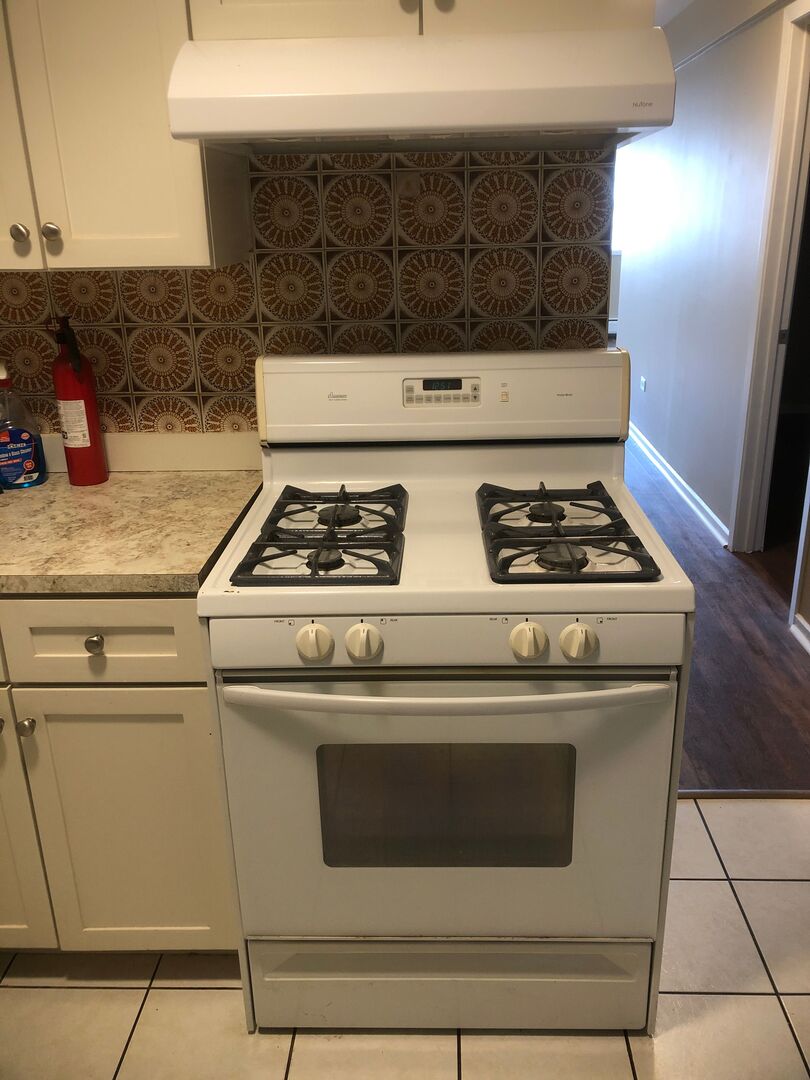 6742 West 63rd Street, Unit 1 Chicago, IL 60638 - Photo 6 of 21 a stove top oven sitting inside of a kitchen