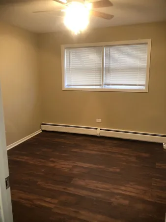 a view of a room with wooden floor and window