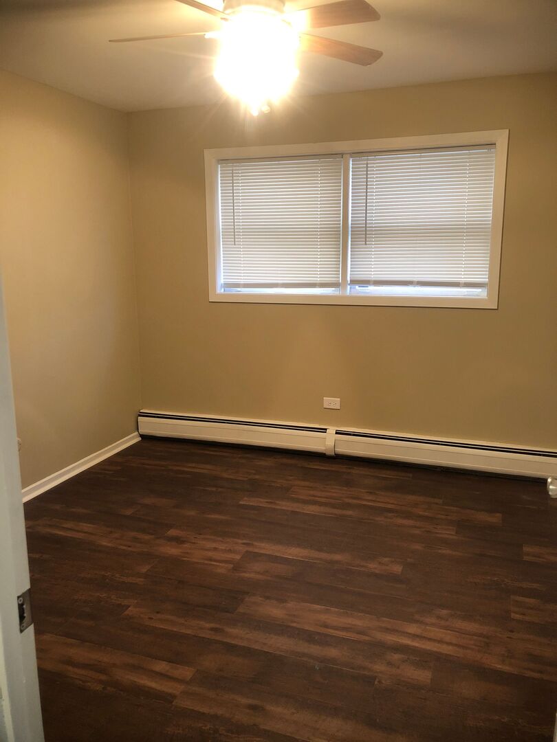 6742 West 63rd Street, Unit 1 Chicago, IL 60638 - Photo 9 of 21 a view of a room with wooden floor and window