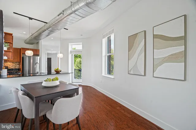 a view of a dining room with furniture and wooden floor