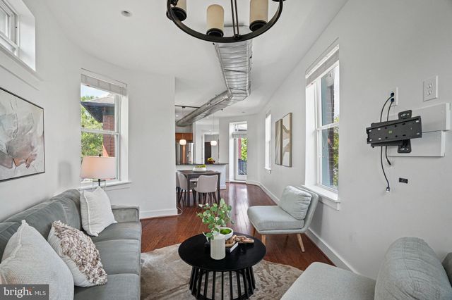 a living room with furniture a chandelier and a table