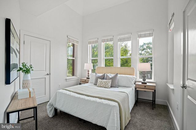 a bedroom with a bed and a chair