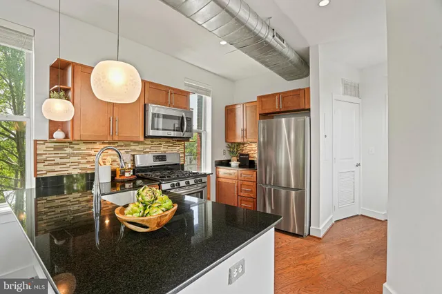 a kitchen with a refrigerator and a stove