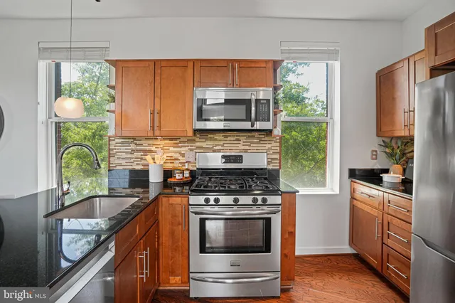 a kitchen with a stove a sink and a microwave
