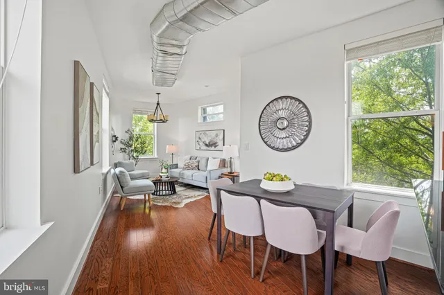 a view of a dining room with furniture window and wooden floor
