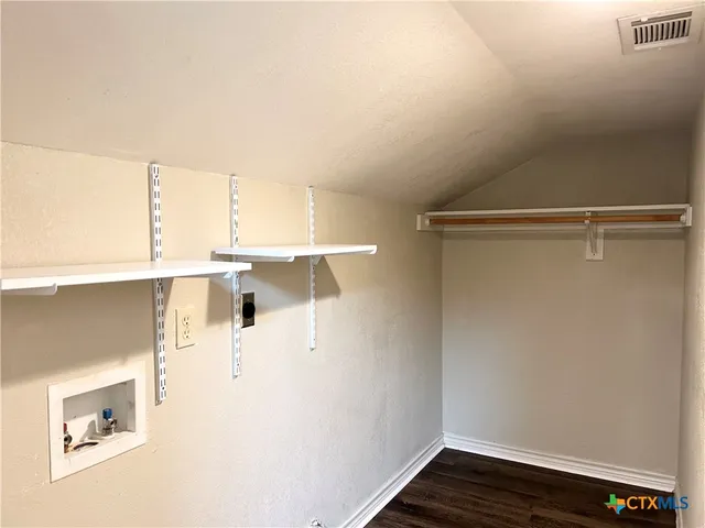 a view of a room with wooden floor