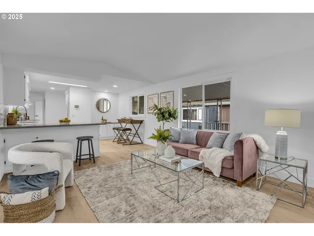 a bathroom with a sink a mirror and a painting on the wall