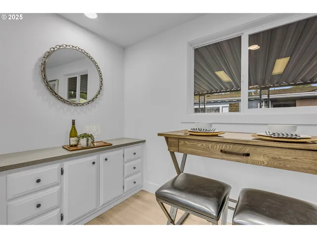 a kitchen with kitchen island granite countertop a sink cabinets and stainless steel appliances