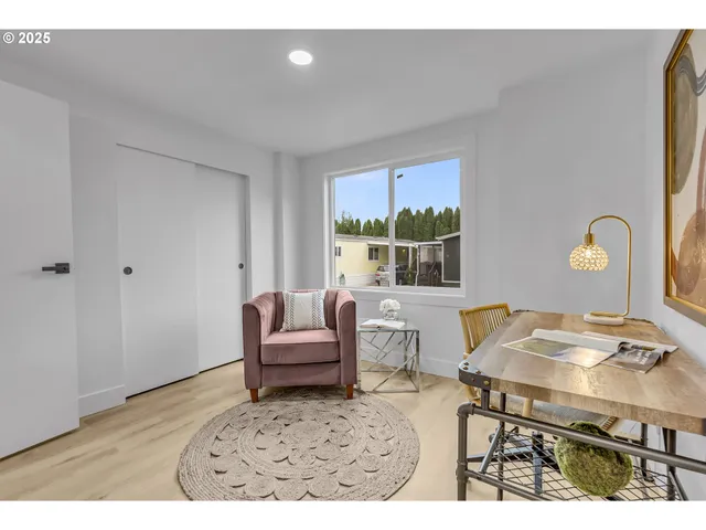 a living room with furniture a window and a table