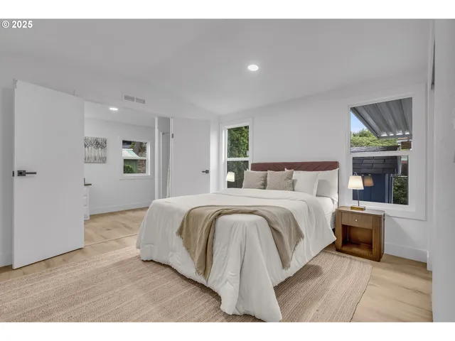 a bedroom with a bed and a view of kitchen