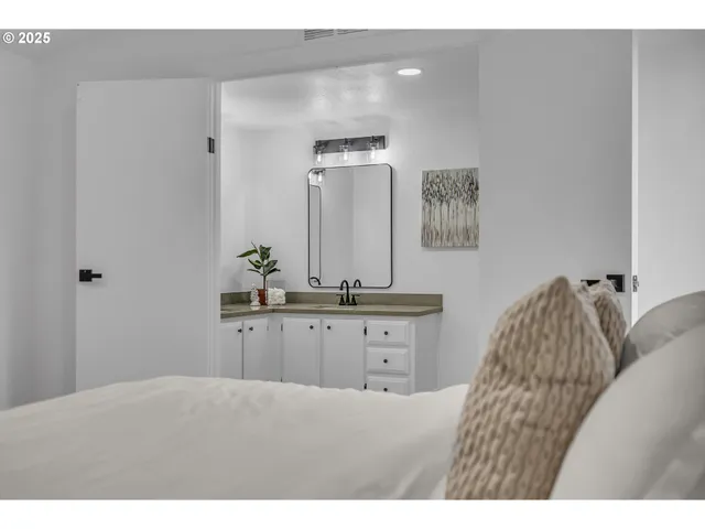 a bathroom with a granite countertop sink mirror and vanity