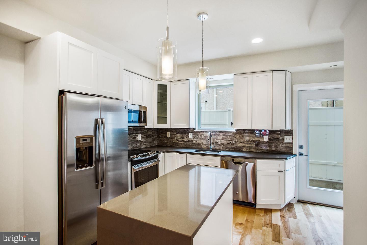 3401 Hamilton Street, Unit 4 Philadelphia, PA 19104 - Photo 16 of 33 a kitchen with stainless steel appliances granite countertop a stove a refrigerator and a sink