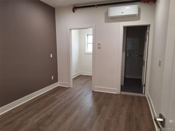 an empty room with wooden floor and closet