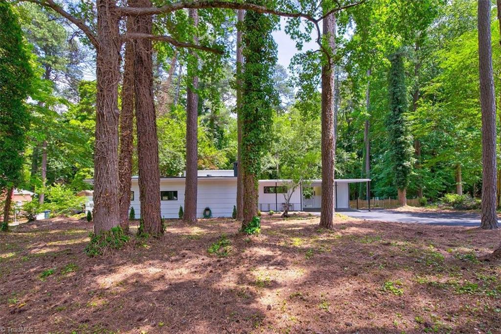 140 Penny Road Jamestown, NC 27282 - Photo 12 of 34 Home from road view nestled among trees
