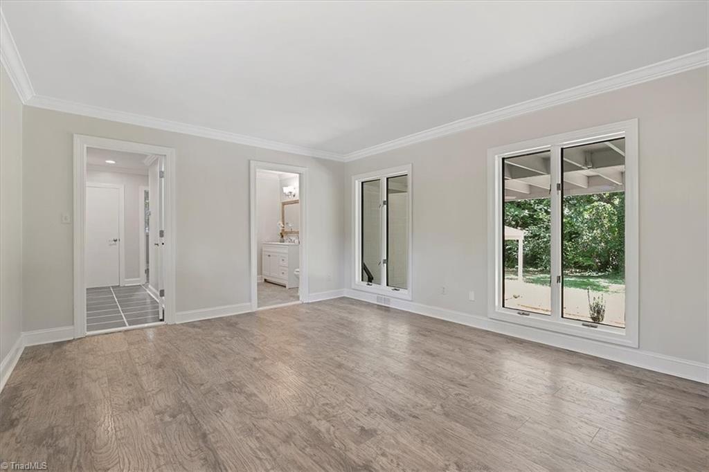 140 Penny Road Jamestown, NC 27282 - Photo 32 of 34 Primary bedroom is incredible with lots of light and view of outdoor space!