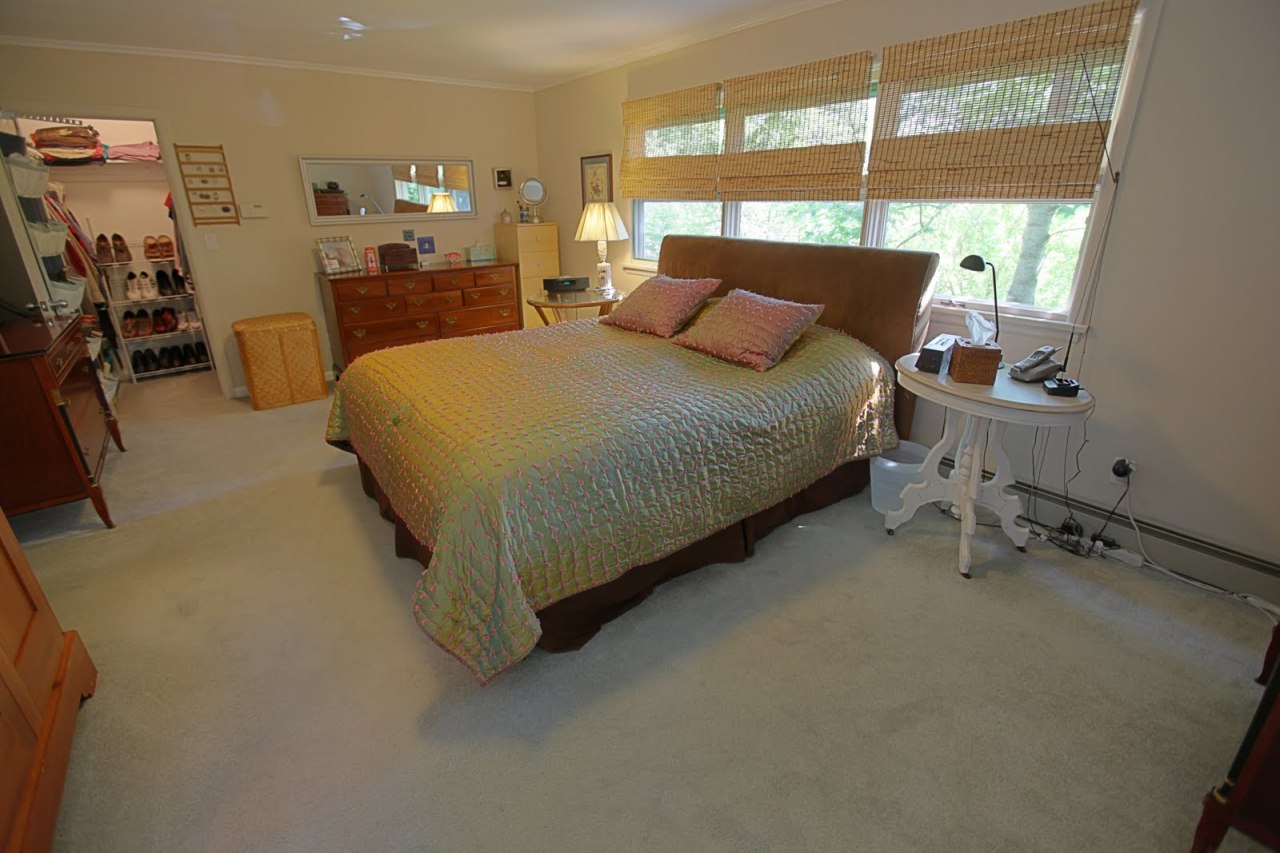 375 Main Road Monterey, MA 01245 - Photo 17 of 19 a bed sitting in a room next to a window