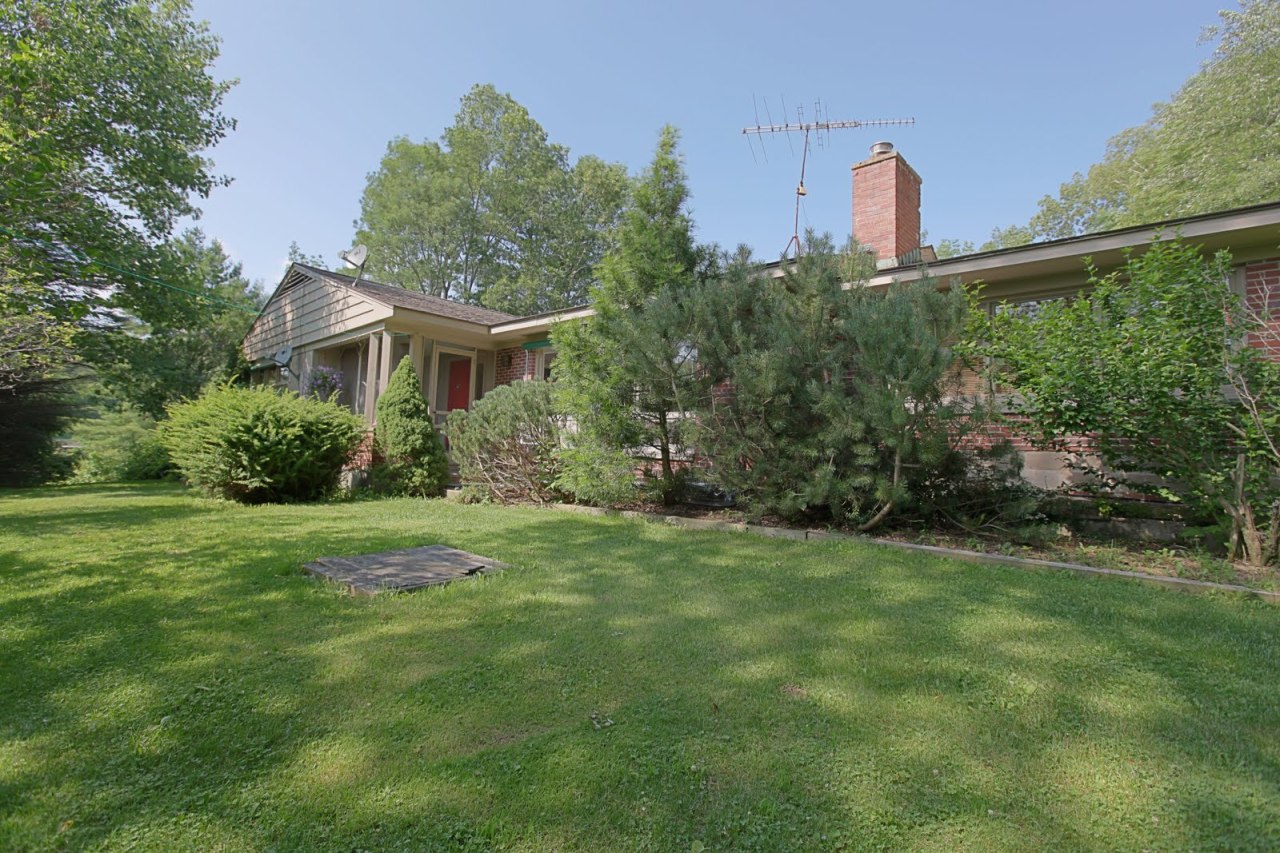 375 Main Road Monterey, MA 01245 - Photo 3 of 19 a front view of a house with a yard