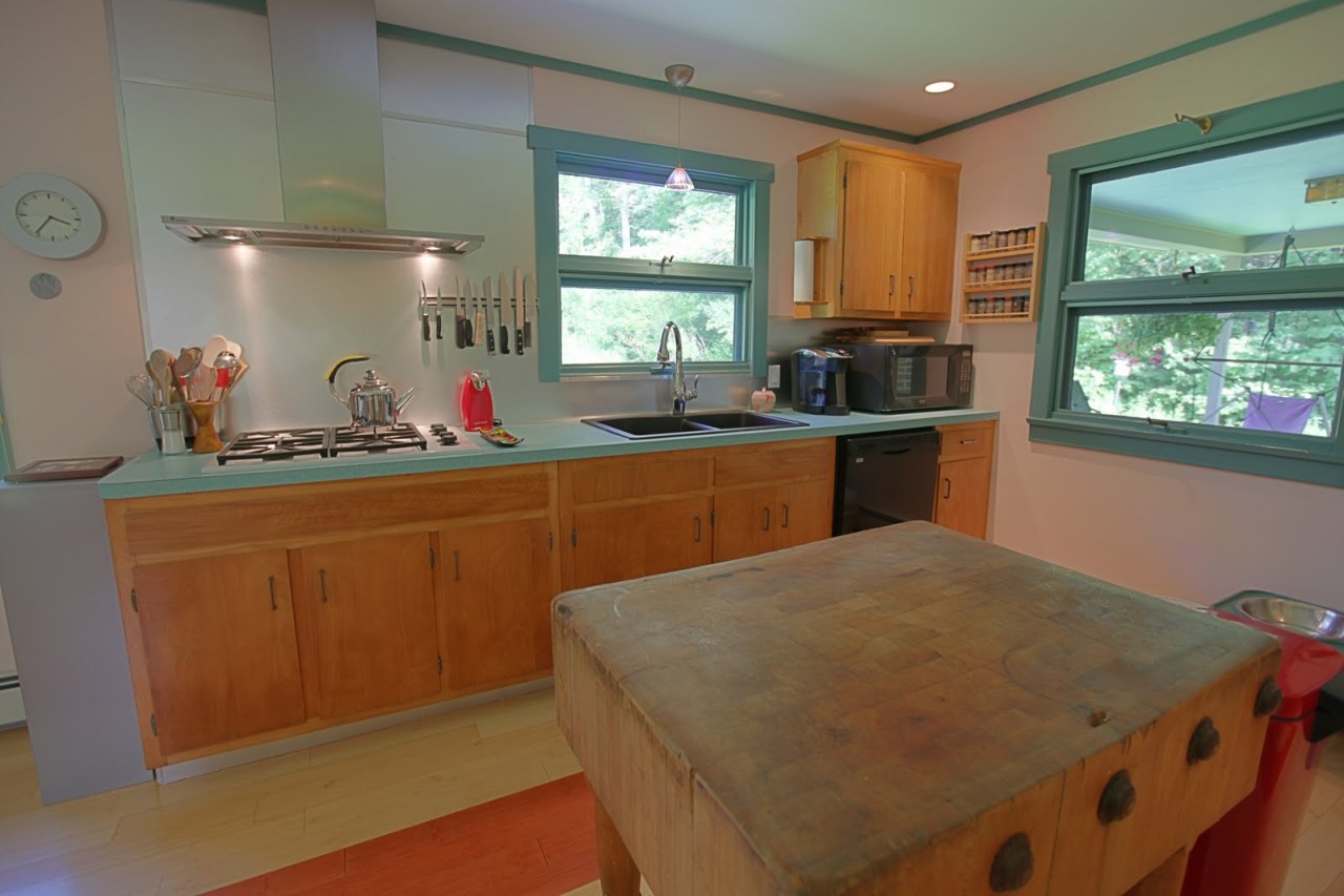 375 Main Road Monterey, MA 01245 - Photo 4 of 19 a kitchen with a sink a window and cabinets