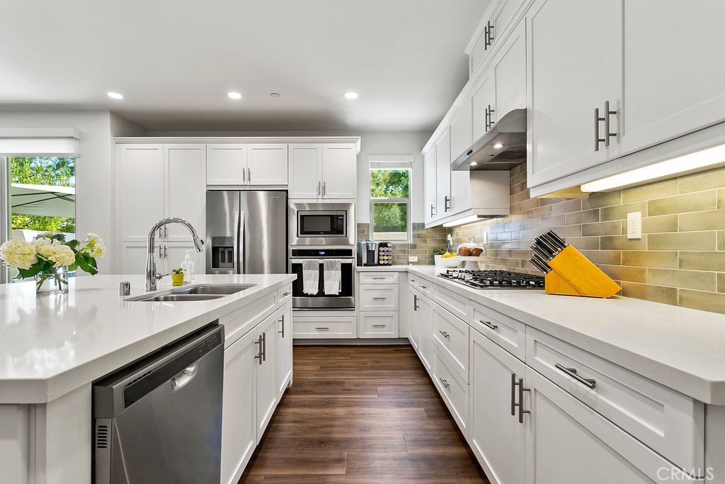 152 Modjeska Irvine, CA 92618 - Photo 10 of 30 a large kitchen with stainless steel appliances lots of counter space and a sink