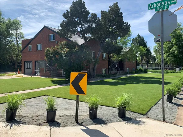 a view of a garden with a slide and a tree