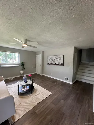 a view of a room with furniture wooden floor and window