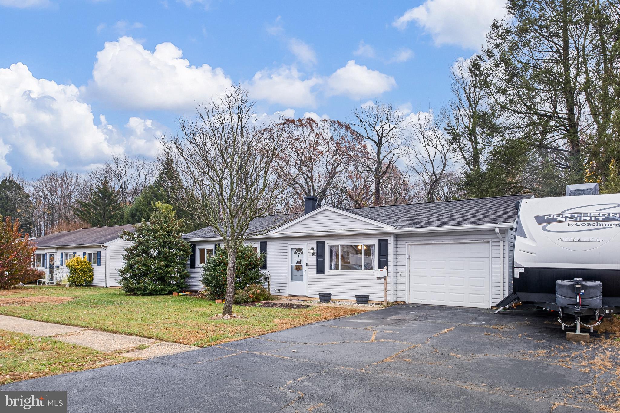 107 Anderson Road Newark, DE 19713 - Photo 25 of 28 a front view of a house with a garden and trees