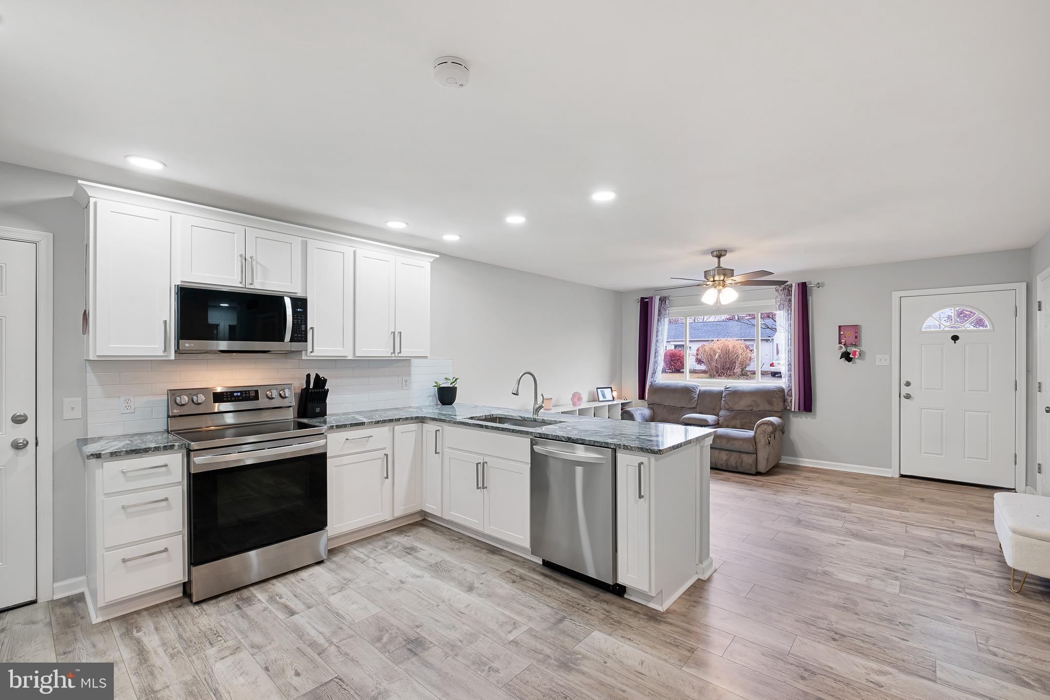 107 Anderson Road Newark, DE 19713 - Photo 5 of 28 a kitchen with granite countertop a sink and steel appliances