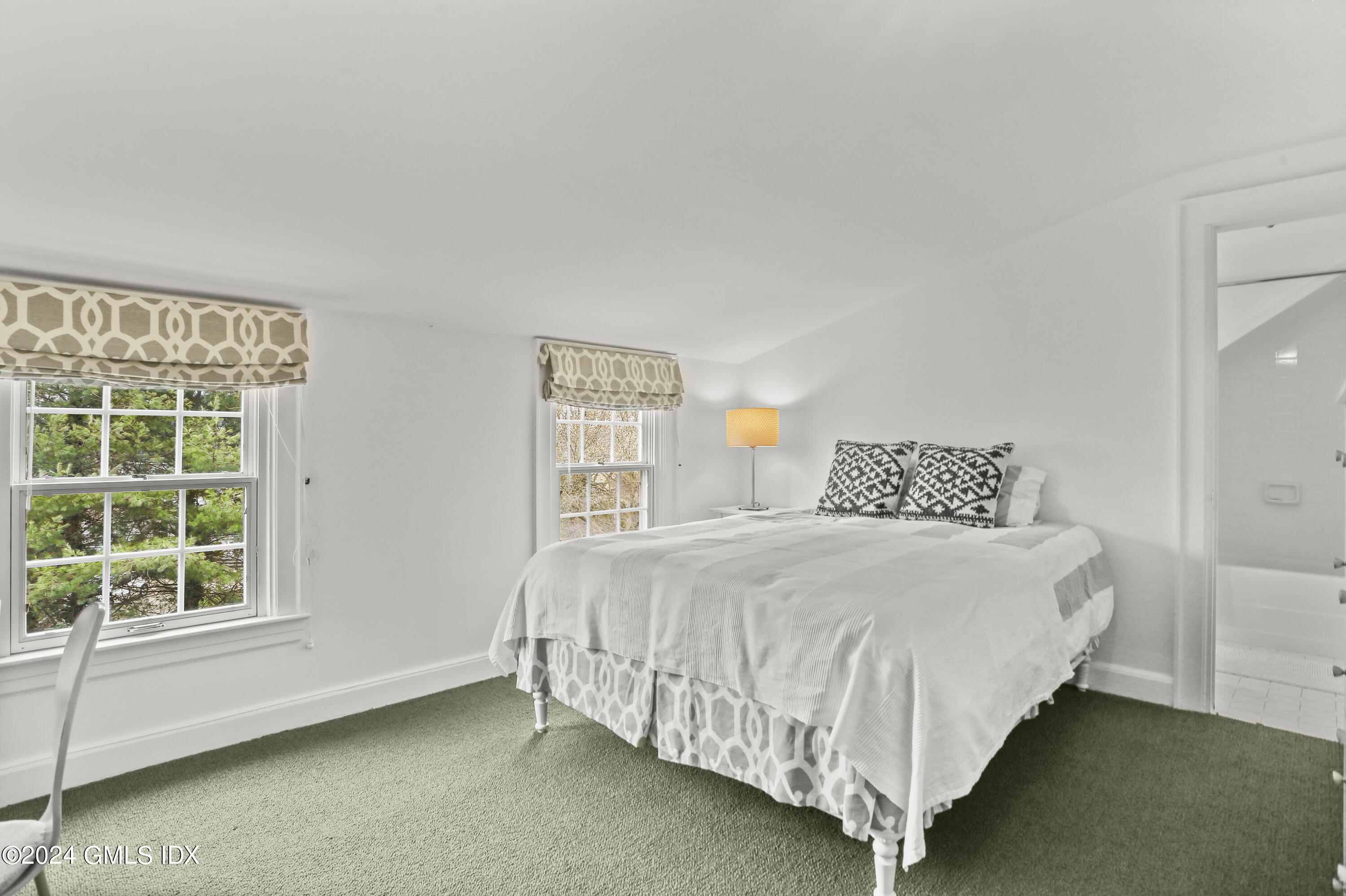 7 Willowmere Avenue Riverside, CT 06878 - Photo 22 of 31 a bedroom with a bed lamp and window