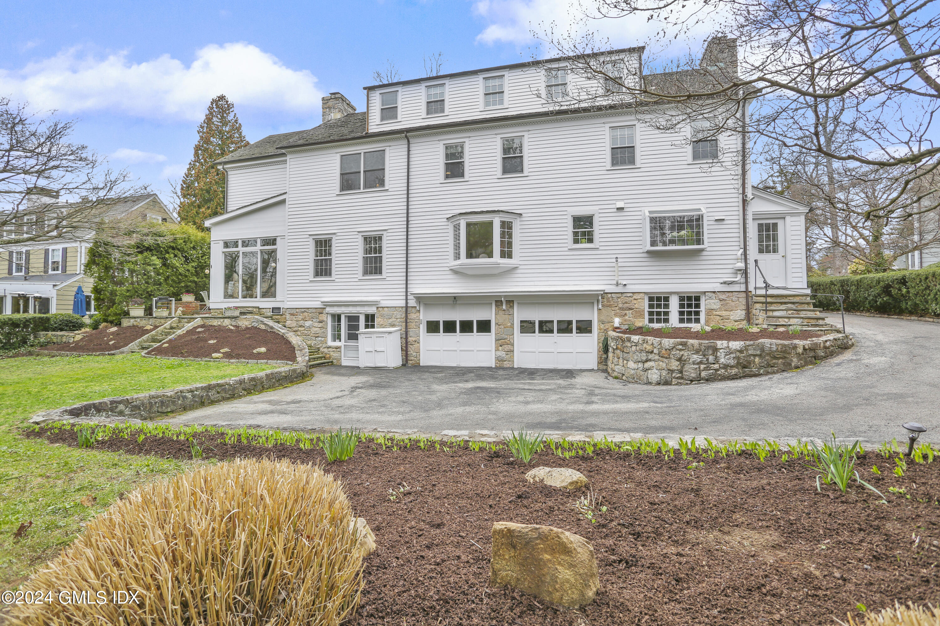 7 Willowmere Avenue Riverside, CT 06878 - Photo 26 of 31 a view of a white house with a yard and plants